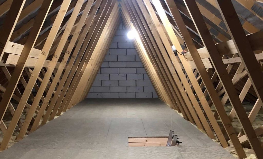 Loft Medics flooring laid between rafters with metal ladder